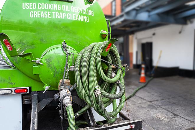 technicians pumping out a commercial grease trap in Ashville